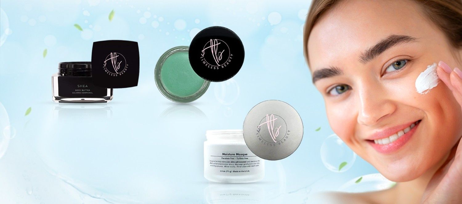 A smiling woman applies cream to her cheek, with Timeless Beauty skincare products like body butter and moisture masque displayed on a fresh, blue background with bubbles and leaves.