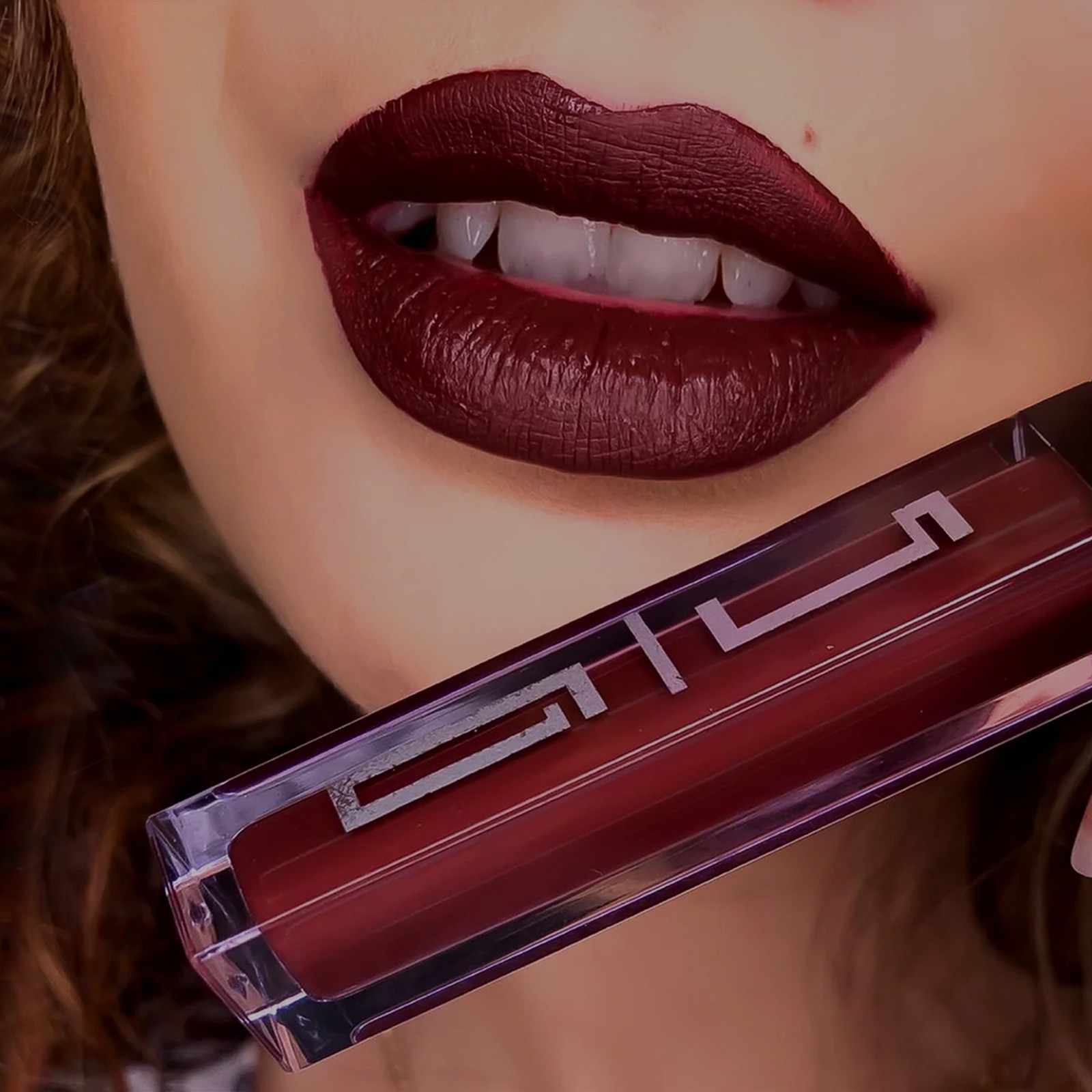 Close-up of bold burgundy lips with matte finish, featuring Timeless Beauty liquid lipstick in deep wine shade.
